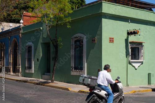 Mexico streets corner with anonymous bike rider  photo