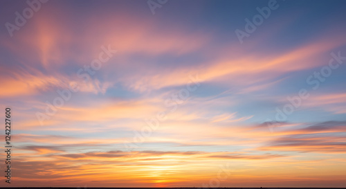 Dramatic sky with fast-moving wispy cirrus clouds illuminated by the setting sun