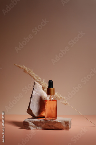 composition with a dropper bottle with a golden cap photo