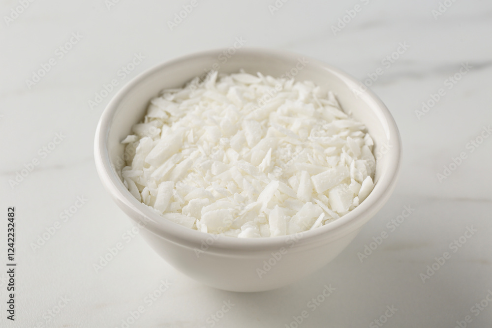Soy wax in bowl on white marble table Soy wax in bowl on white marble table