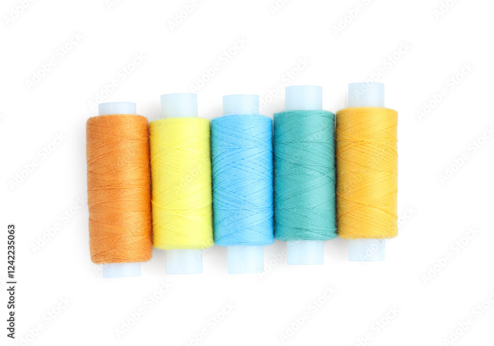 Spools of bright sewing threads isolated on white, top view Spools of bright sewing threads isolated on white, top view