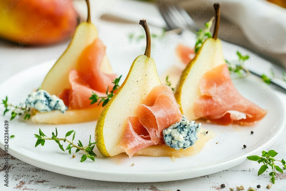 Appetizer with pear, blue cheese and prosciutto ham for holidays on a white plate. Appetizer with pear, blue cheese and prosciutto ham for holidays on a white plate.