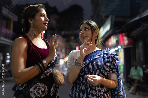 Indian woman walking through city street photo