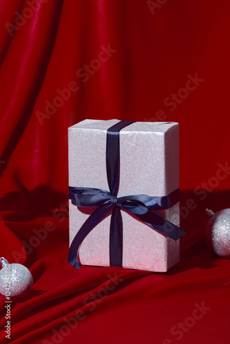 Beautifully Wrapped Christmas Gift on Red Background photo