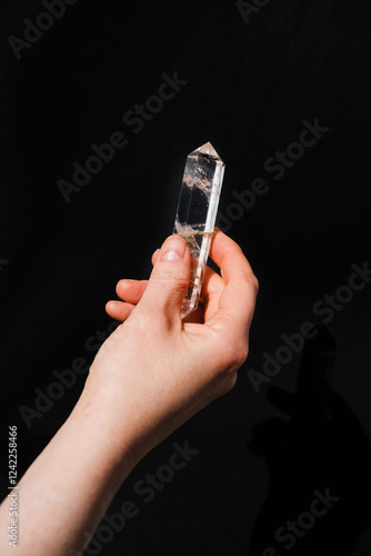 Hand holding a clear quartz photo