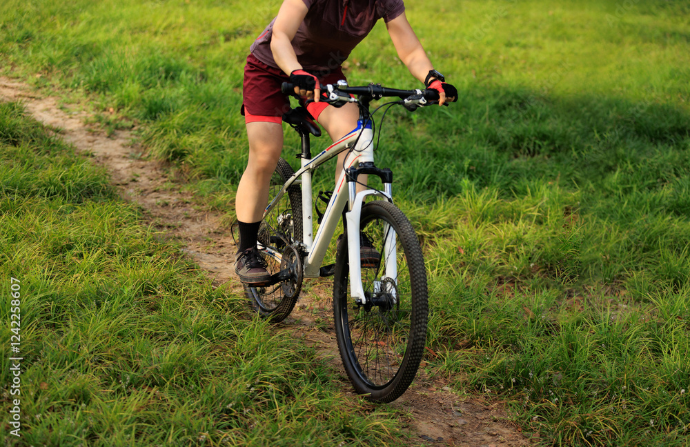 Woman mountain biking on mountain trail Woman mountain biking on mountain trail