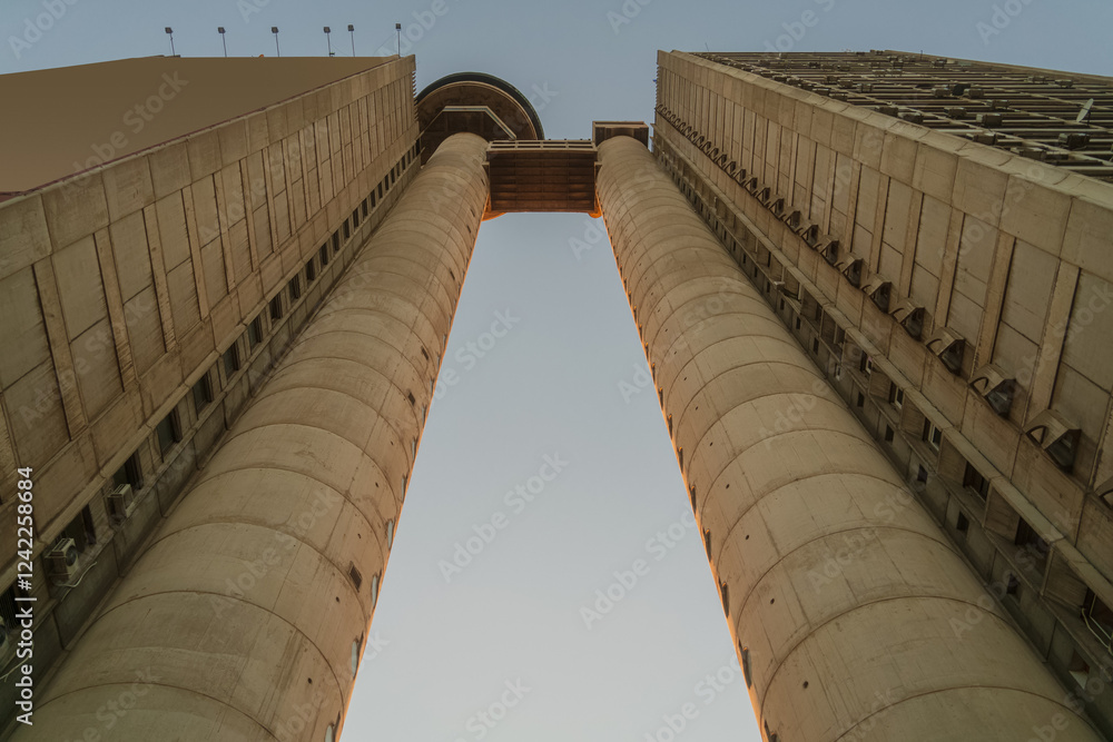 Brutalism socialist architecture buildings of Genex Tower or Western City Gate in New Belgrade Block district at sunset