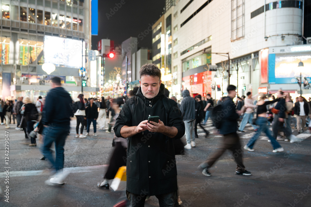 Man using phone on the street at night Man using phone on the street at night