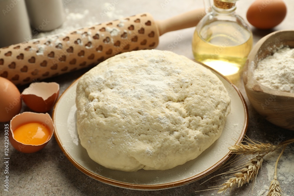 Fresh dough, ingredients and rolling pin on grey table, closeup Fresh dough, ingredients and rolling pin on grey table, closeup