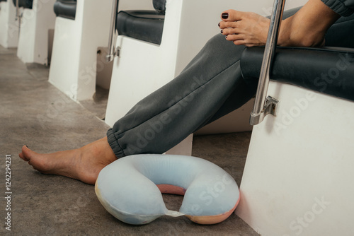 Relaxation on public transport with neck pillow and bare feet photo