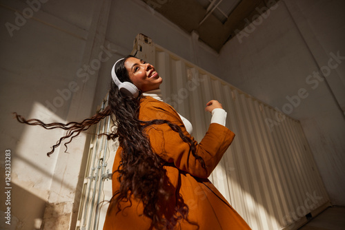 Stylish woman in headphones listening to music