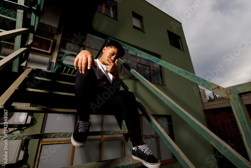 Teenager seated on staircase  photo