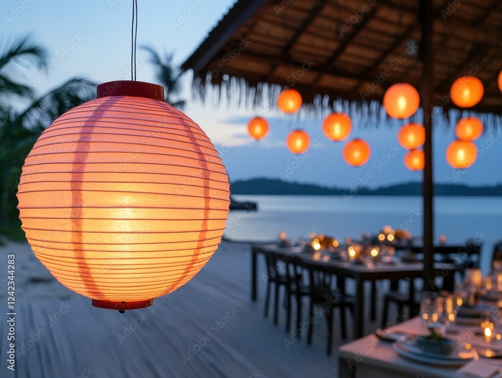 Fototapeta premium Cozy Outdoor Dining Setting with Lanterns at Sunset by the Water