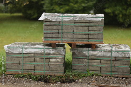 Three stacks of bricks are on a wooden pallet photo