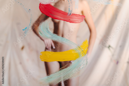Artsy naked woman with colorful paint strokes