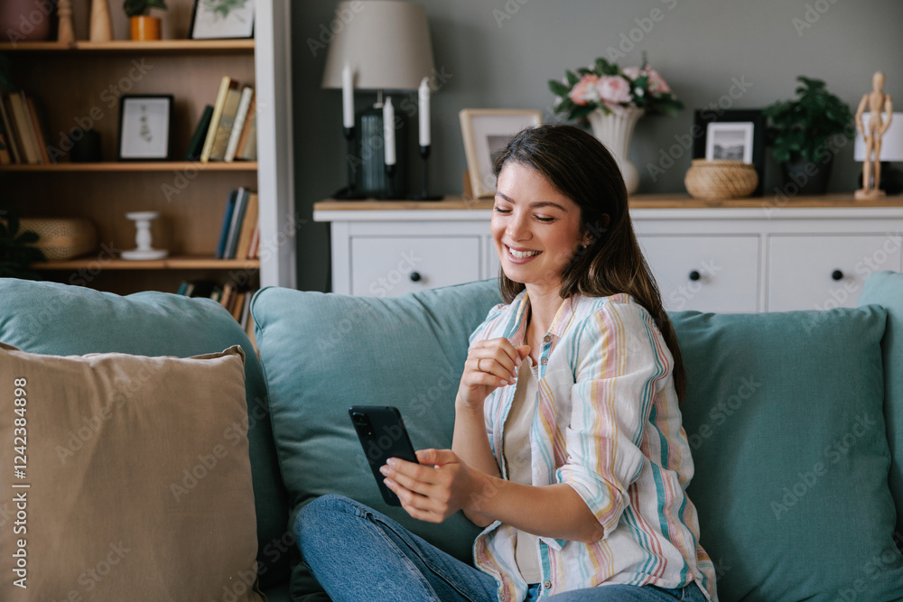 Woman having a video call using smartphone at home Woman having a video call using smartphone at home
