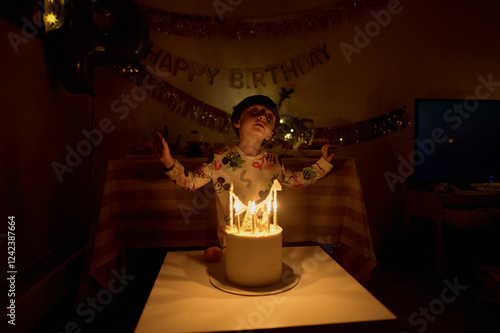 little boy blowing out candles photo