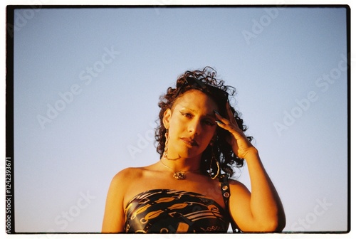 Trans woman looking at camera at sunset photo