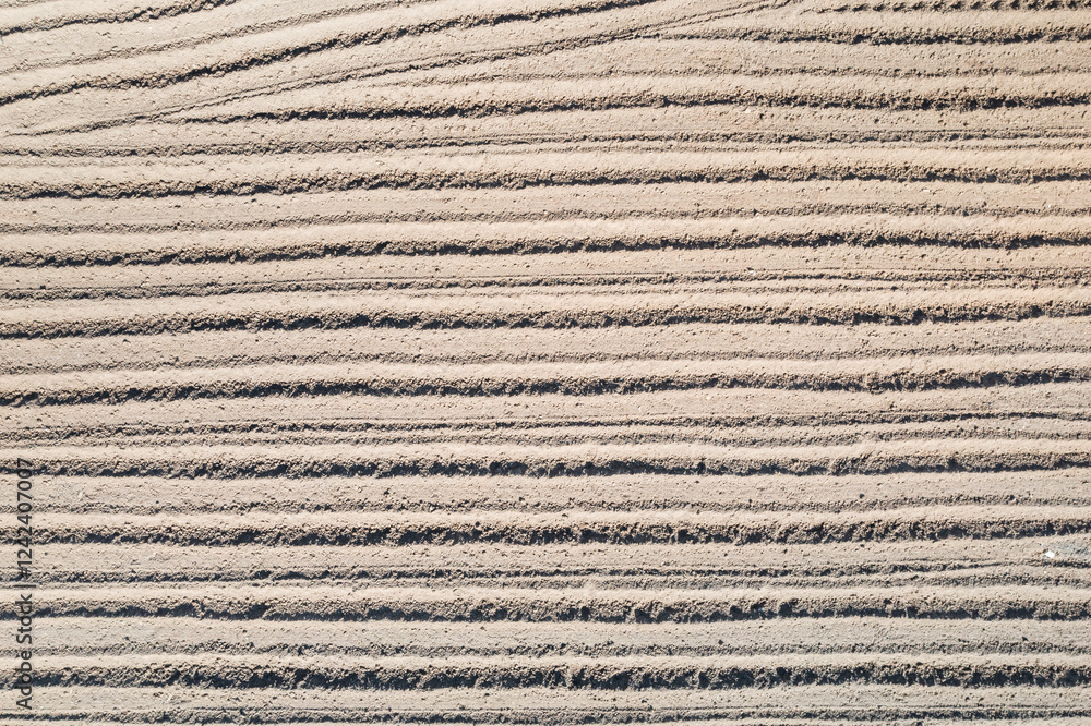 Freshly plowed furrows in a cultivated field Freshly plowed furrows in a cultivated field