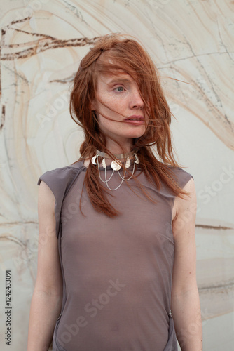 young woman with red hair in see through blouse