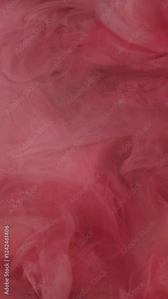 Vertical video. Ink water drop. Smoke cloud. Defocused red pink color shimmering glitter floating underwater explosion blob reveal motion dreamlike abstract art background. Vertical video. Ink water drop. Smoke cloud. Defocused red pink color shimmering glitter floating underwater explosion blob reveal motion dreamlike abstract art background.