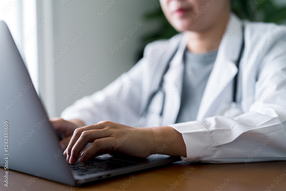 Doctor working on laptop with stethoscope at office. Online healthcare, digital patient records, telemedicine services, remote consultations and medical technology. Doctor working on laptop with stethoscope at office. Online healthcare, digital patient records, telemedicine services, remote consultations and medical technology.