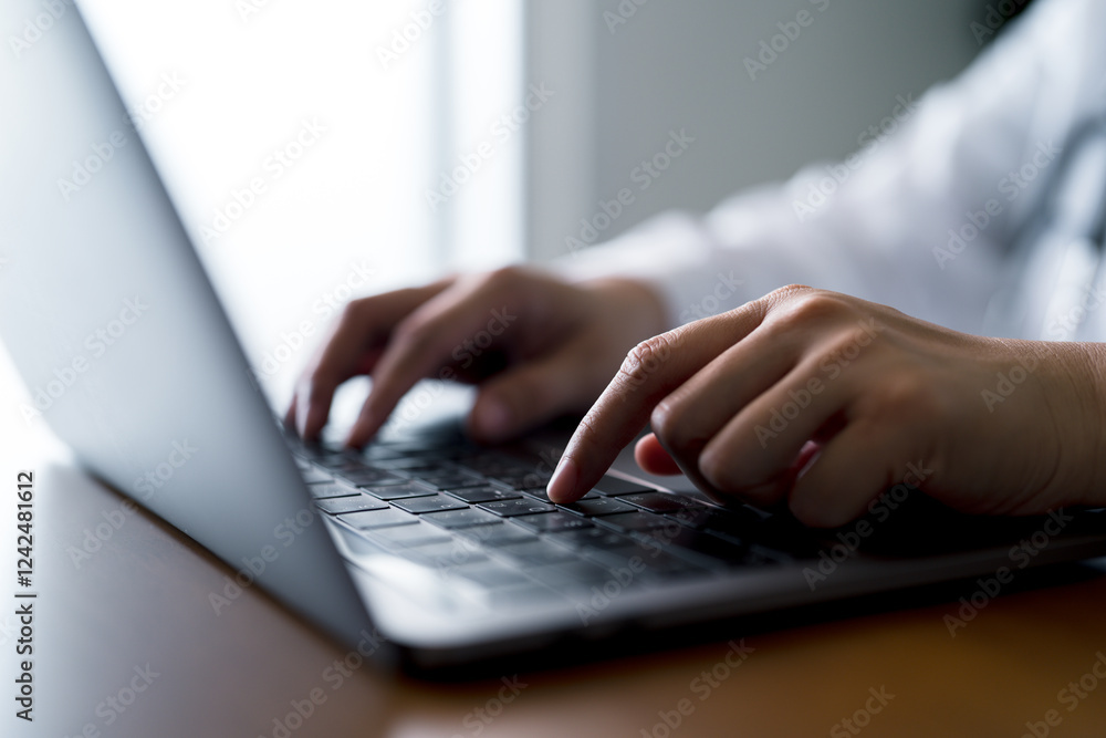 Medical professional using laptop with a stethoscope at office. Digital healthcare, telehealth services, virtual consultations, online medical records and remote healthcare technology. Medical professional using laptop with a stethoscope at office. Digital healthcare, telehealth services, virtual consultations, online medical records and remote healthcare technology.