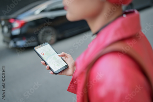 Traveler Gen z girl leather fashion with punk Asian woman tourist in city street searching location in map application online smart phone using GPS navigating