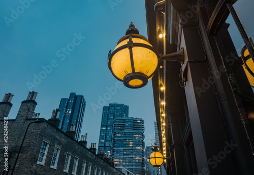 City street lamp illuminating modern London evening skyline photo