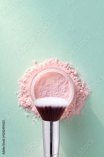 Loose Pink Powder Makeup With Brush On Green Background photo