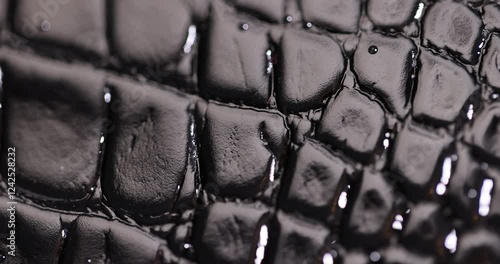 wet genuine black leather Imitating crocodile leather for making objects, black polished leather dyed black with embossed crocodile leather covered with water droplets