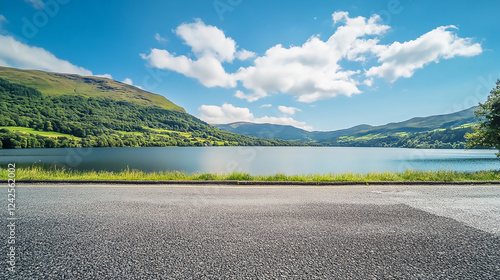 A winding tree-lined road passes a stream and rocky outcroppings in its climb through the mountains Winding road in the mountains at sunset, stretching into the distance
