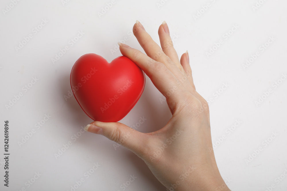 female hands hold red symbolic heart isolated on white background. love, like concept.