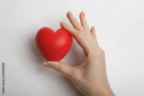 Obraz na płótnie female hands hold red symbolic heart isolated on white background. love, like concept. w salonie