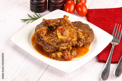 Italian cuisine - ossobuco with sauce photo