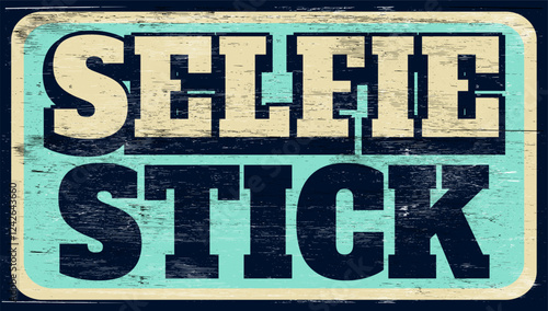 Aged and worn selfie stick sign on wood