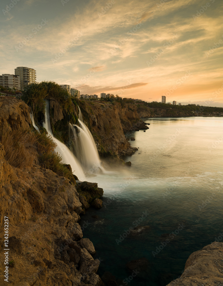 Obraz premium Lower Duden Falls at sunrise. The Mediterranean coast. Duden Waterfall ( Turkish: Düden Şelalesi ) is a popular tourist attraction of Antalya. Turkey country - vertical photo