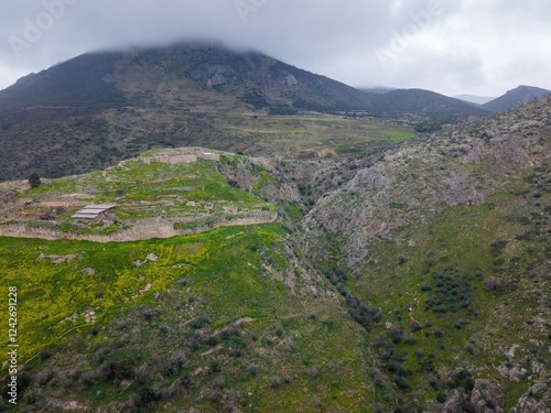 Mycenae, Greece. Excavation site: Greek settlement of the 12th century BC. e. with the ruins of the acropolis, palace and tombs, Aerial View  photo