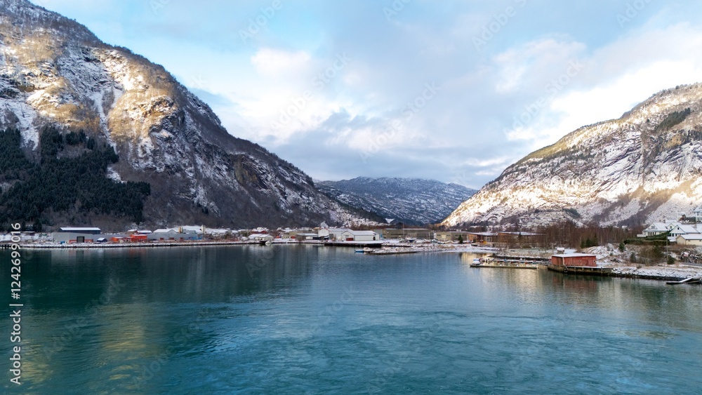 Obraz premium Winter Aerial View of Gaupne, Norway with Fjord, Harbor, and Snowy Mountains 