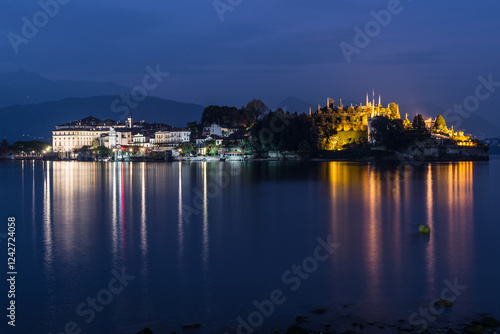 Lake Maggiore and Stresa city at dusk, Italy. Isola Bella (beautiful island) view from the lakeside of Stresa with the lights reflected in the waters of the lake