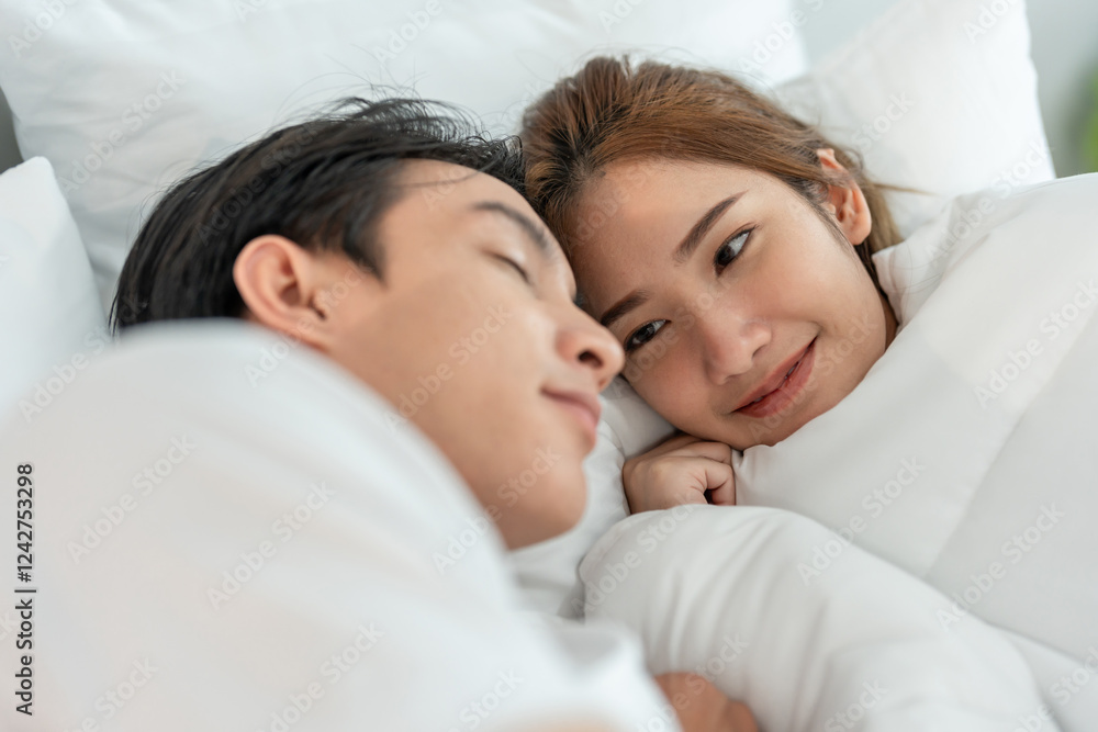 Asian attractive young couple lying down on bed to sleep in bedroom. Asian attractive young couple lying down on bed to sleep in bedroom.