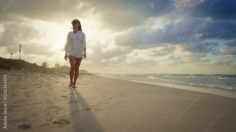 Sexy woman with slender legs walking on sandy beach alone in summer morning. Happiness and joy, spending summertime in warm southern region, trip to Caribbean, enjoy calmness and solitude in nature Sexy woman with slender legs walking on sandy beach alone in summer morning. Happiness and joy, spending summertime in warm southern region, trip to Caribbean, enjoy calmness and solitude in nature