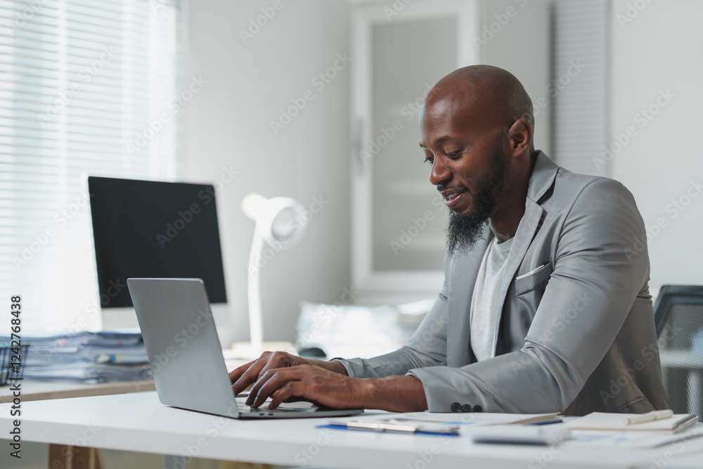 Business professional focused on work, typing on a laptop in a modern office setting. Natural light illuminates the space, creating a productive and serene work environment Business professional focused on work, typing on a laptop in a modern office setting. Natural light illuminates the space, creating a productive and serene work environment