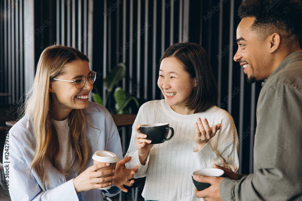 Diverse business team enjoying coffee break and sharing conversation Diverse business team enjoying coffee break and sharing conversation