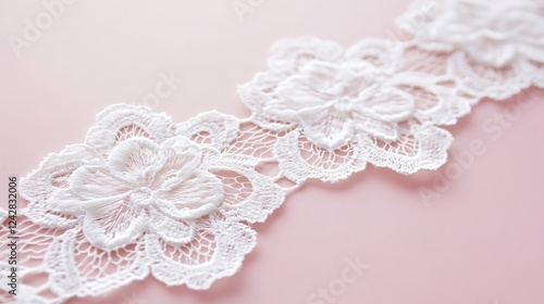 White floral lace fabric on pink