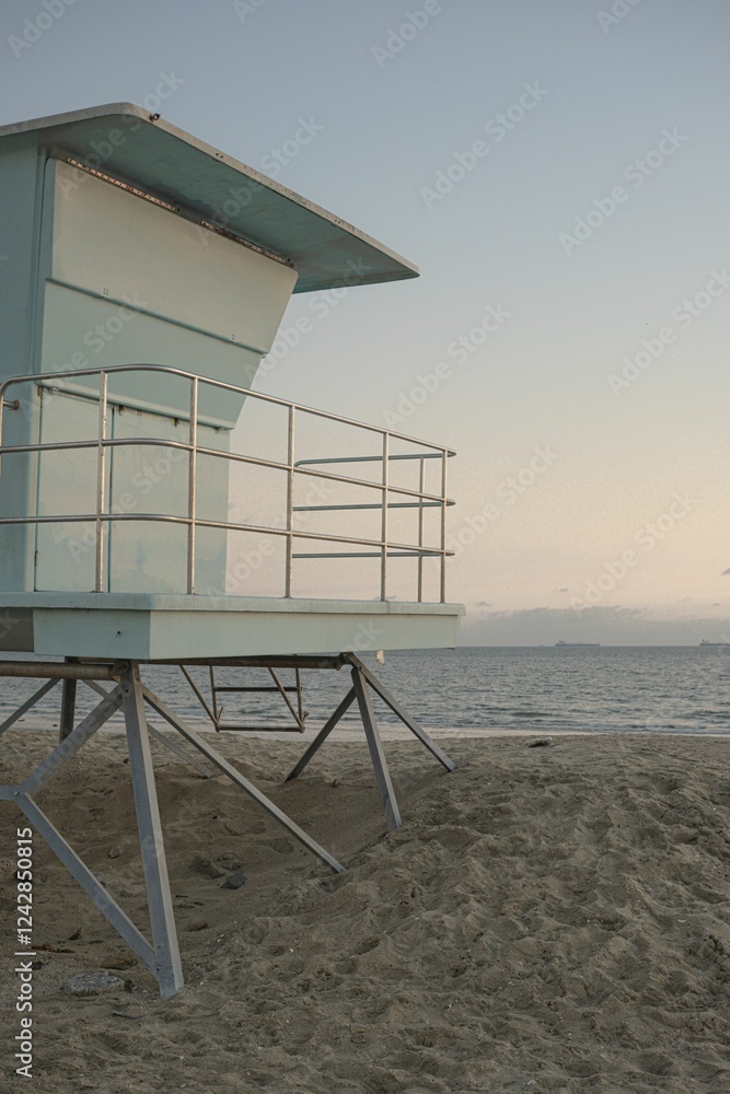 Serene beach scene with a lifeguard tower at sunset in Long beach in January, Los Angeles Serene beach scene with a lifeguard tower at sunset in Long beach in January, Los Angeles
