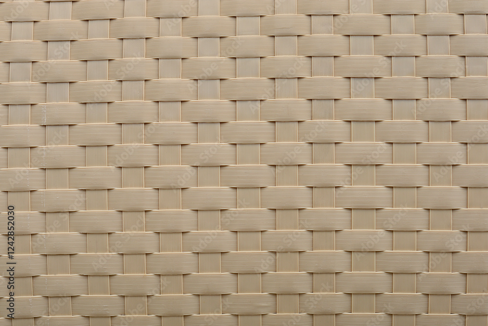 A detailed view of a textured plastic surface, featuring interwoven patterns and subtle shadows A detailed view of a textured plastic surface, featuring interwoven patterns and subtle shadows