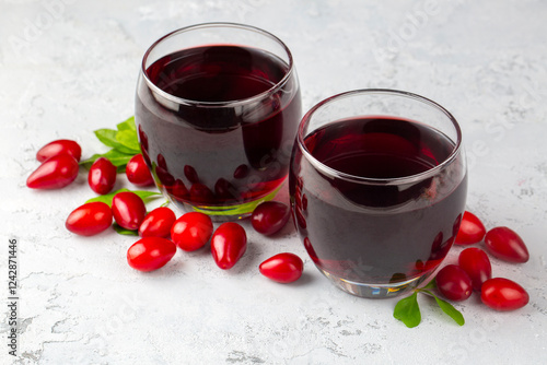 Glass of healthy dogwood berry drink on light background. Turkish name; Kizilcik serbeti photo