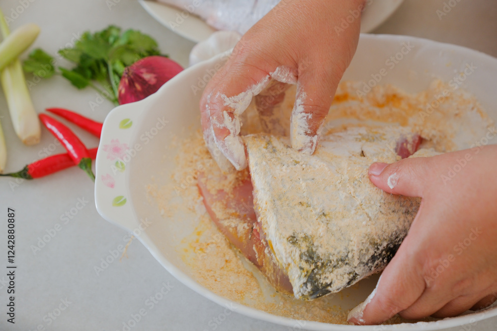 Hands of woman chef preparing fish food