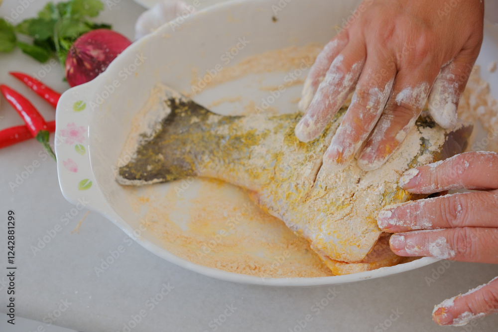 Hands of woman chef preparing fish food